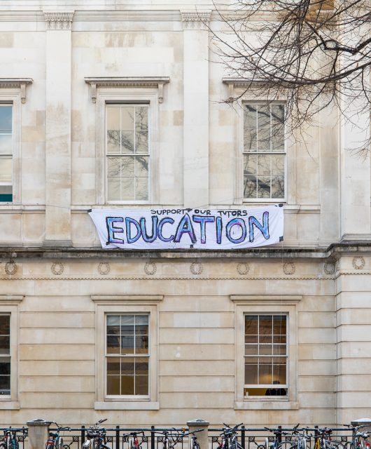A banner hanging from the Slade School of Fine Art, with the message: Education - support our tutors